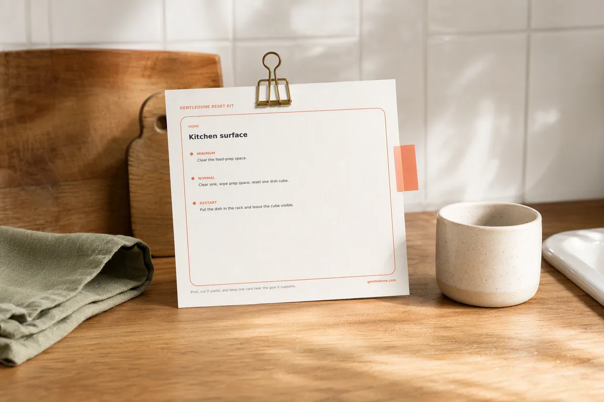 A GentleDone reset card placed beside a calm, lived-in kitchen work surface.